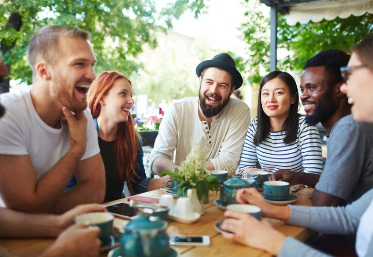 Friends laughing together around a table