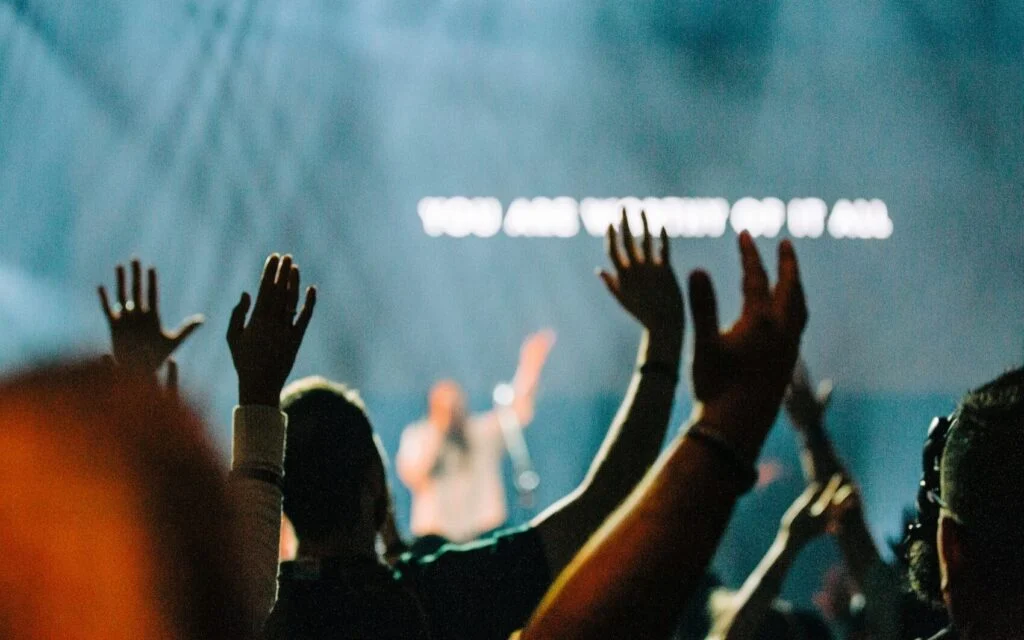 Hands raised in worship during a service