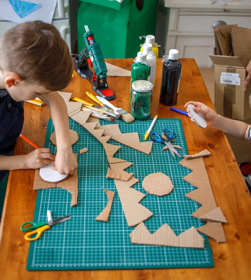 Two boys doing cardboard crafts at Vacation Bible School