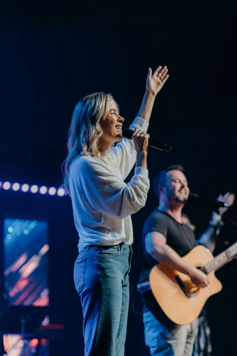 A worship leader sings at Antioch Church
